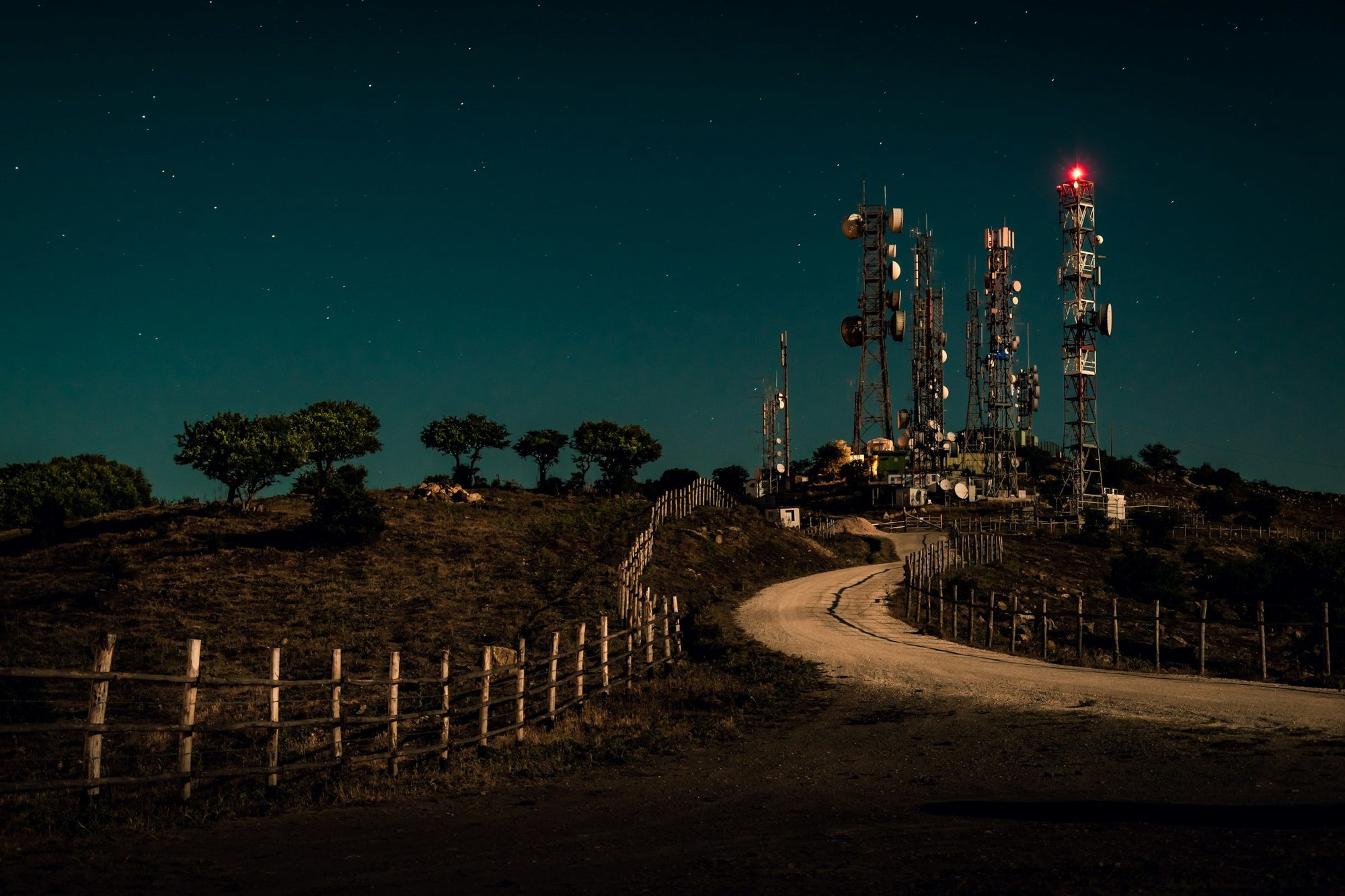Communications towers on a hill above Civitavecchia, Italy, at night